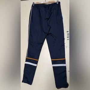Puma Mid-rise navy sweatpants with zipper on both legs.